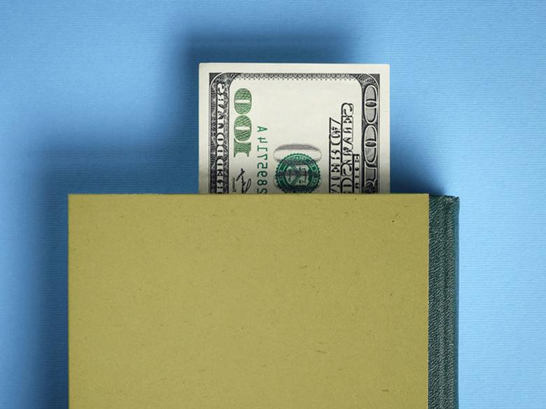 100 dollar bill used as a bookmark